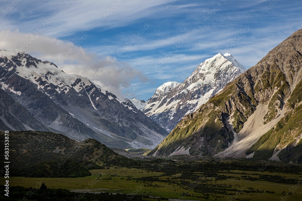 snow covered mountains on a sunny day in new zealand,