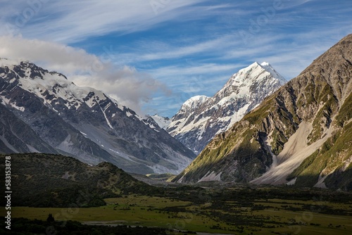 snow covered mountains on a sunny day in new zealand,