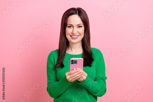 Photo of pretty cheerful lady dressed green pullover chatting instagram twitter telegram facebook isolated pink color background