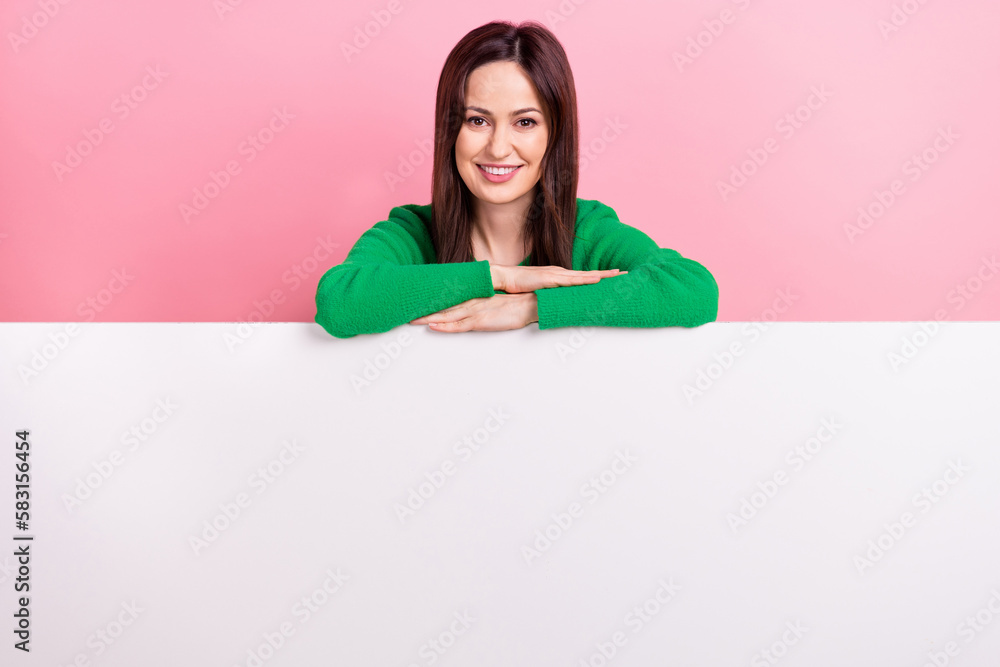 Photo of adorable pretty lady dressed green pullover holding placard emtpy space isolated pink color background Photo of adorable pretty lady dressed green pullover holding placard emtpy space isolated pink color background