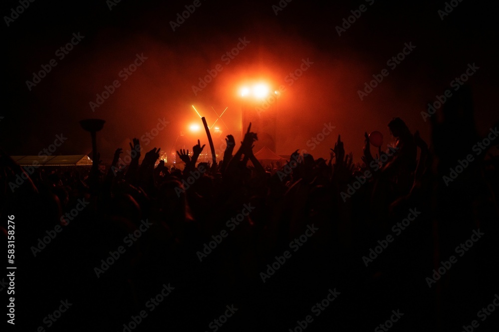 Beautiful shot of hand silhouettes of a crowd at a concert