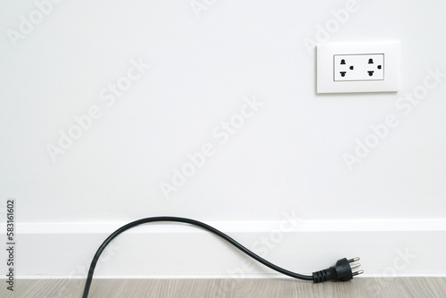 Close Up the electrical power socket and plug socket on wall.