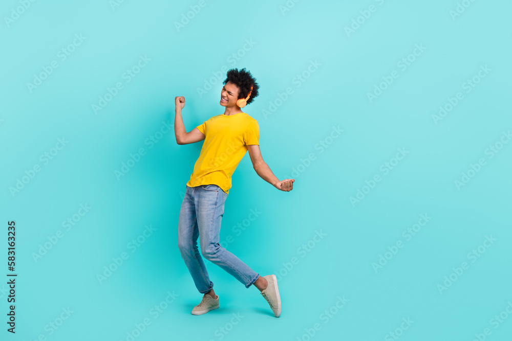Full size portrait of excited positive person enjoy listen music dancing isolated on teal color background Full size portrait of excited positive person enjoy listen music dancing isolated on teal color background