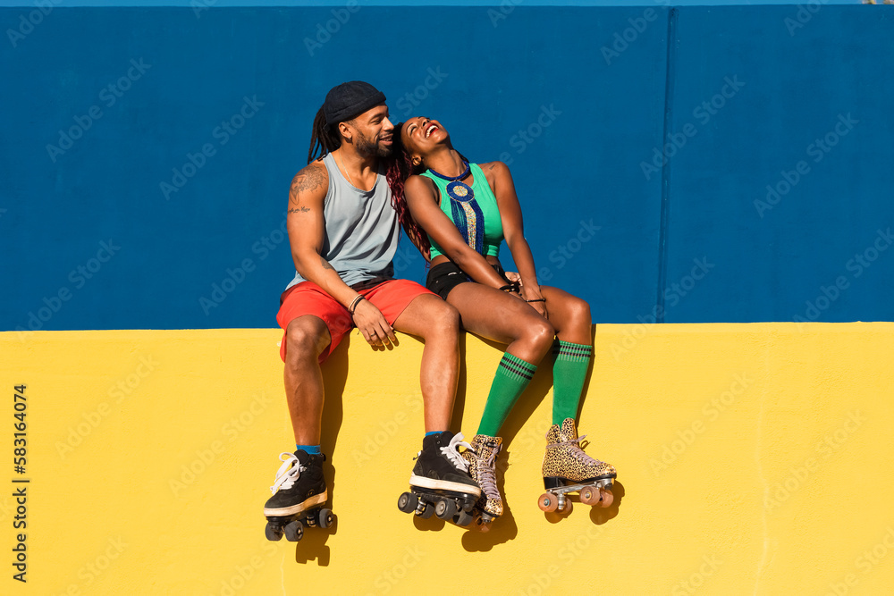 Cheerful couple with roller skating outside. Fun sexy boyfriend and girlfriend enjoy in sunny day