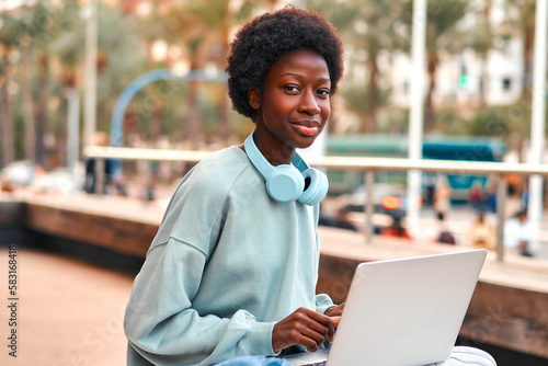 African American woman with laptop outdoors
