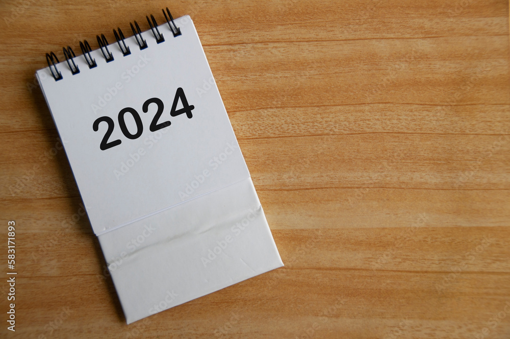 Year 2024 text on white table calendar with customizable space for text or ideas. Copy space and calendar concept. Year 2024 text on white table calendar with customizable space for text or ideas. Copy space and calendar concept.