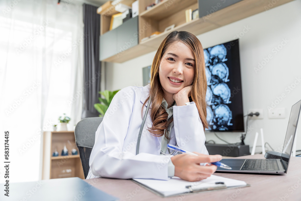 A beautiful Asian doctor in Thailand discusses the condition of a patient undergoing treatment in a doctor's clinic. A beautiful Asian doctor in Thailand discusses the condition of a patient undergoing treatment in a doctor's clinic.