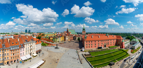 Panorama of Warsaw palace square with historical buildings, royal palace and streets during a sunny day