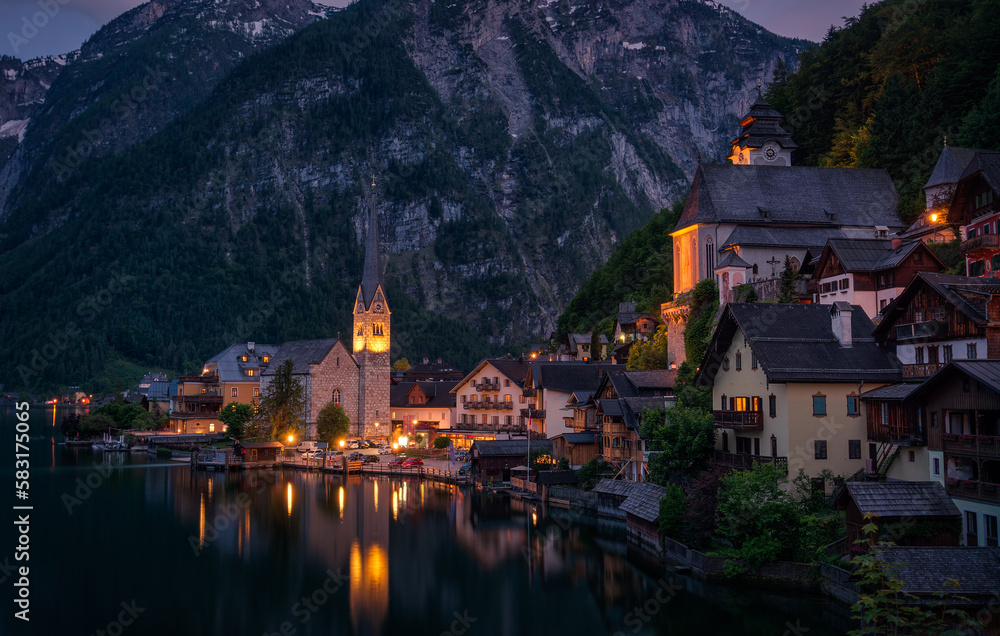 Night panorama of the Austrian village Hallstatt with reflections in the water