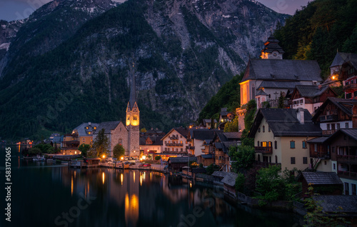 Night panorama of the Austrian village Hallstatt with reflections in the water