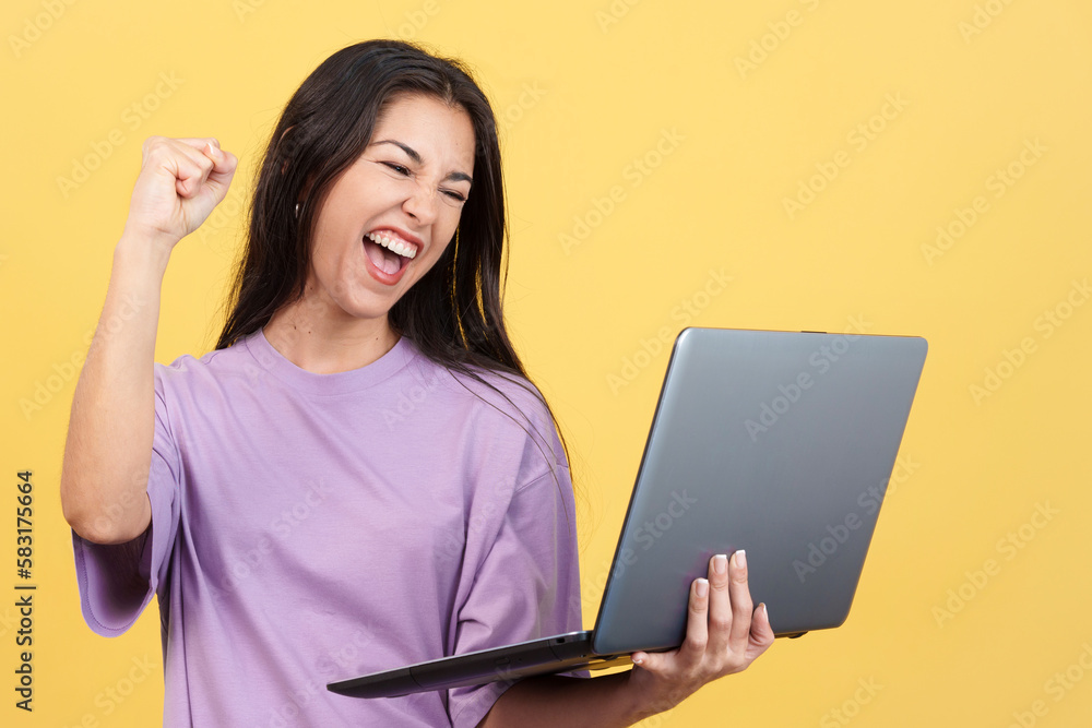Caucasian woman celebrating while looking at the laptop Caucasian woman celebrating while looking at the laptop
