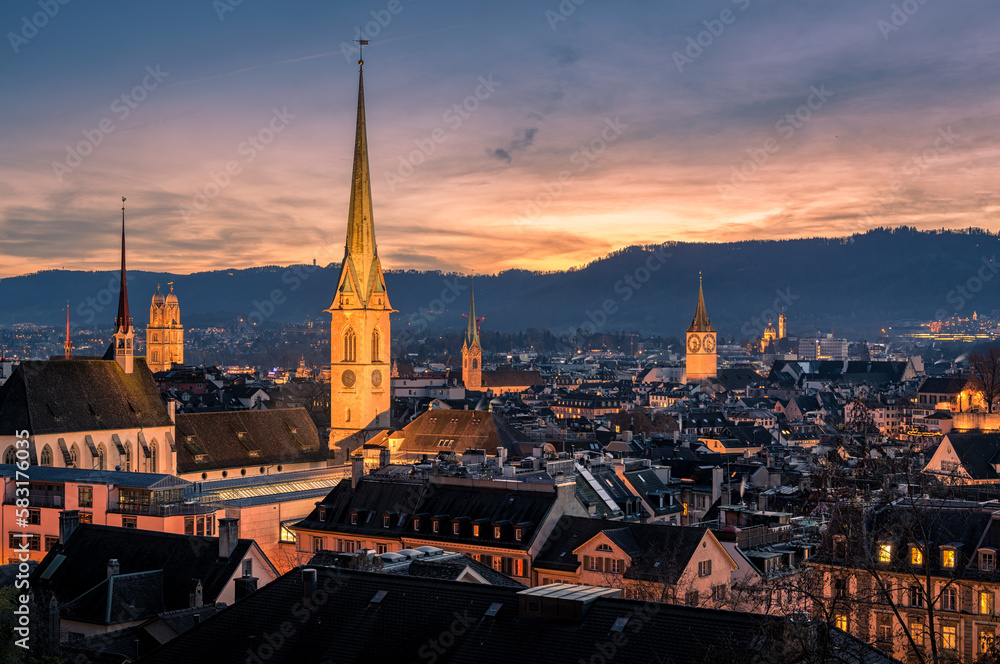 Panorama of Zürich city center with roofs of houses and churches during sunset