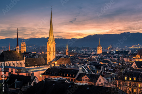 Panorama of Zürich city center with roofs of houses and churches during sunset