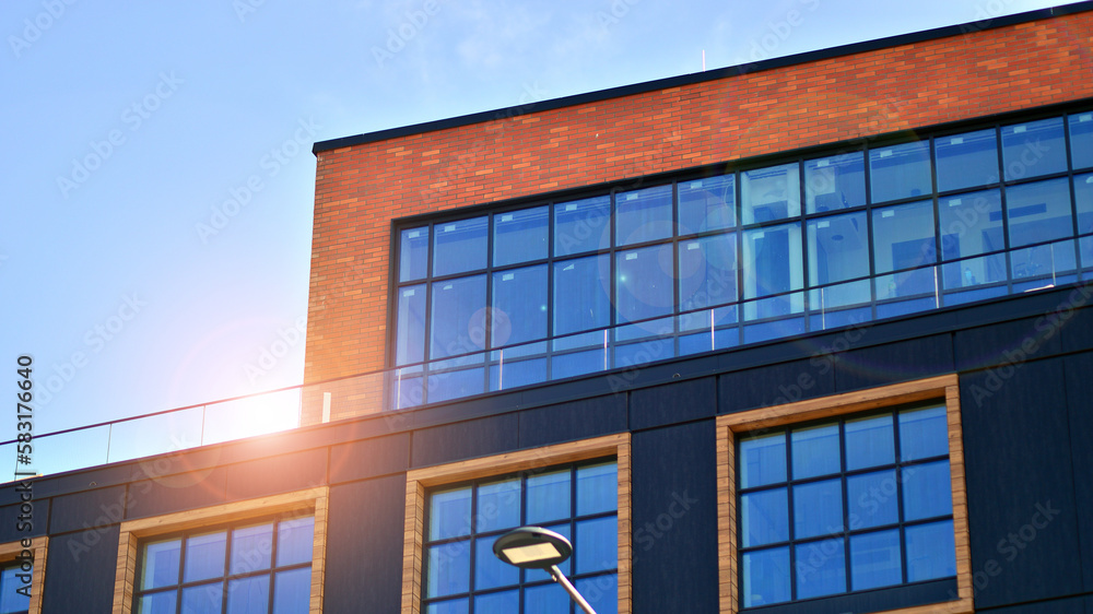 A modern corporate building in the city. The blue sky is reflected in the buildings large glass windows. Glass facade. A modern corporate building in the city. The blue sky is reflected in the buildings large glass windows. Glass facade.