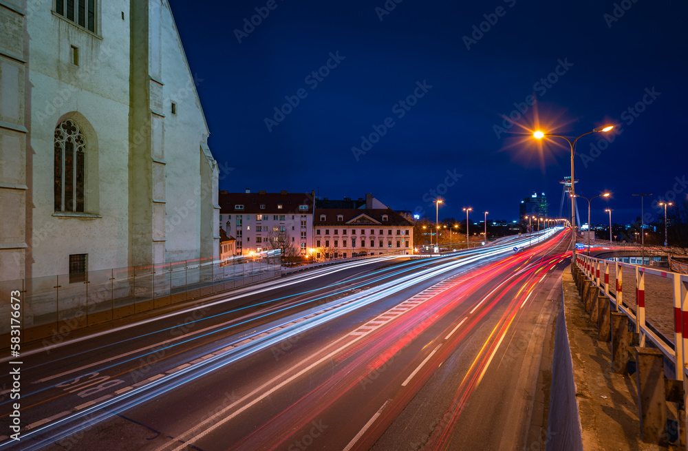 Light trails at night in the city center next to St. Martins dome leading to Petrzalka district via bridge over river Danube 