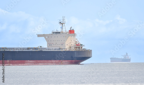 Two cargo ships sailing in ocean, Victoria, British Columbia, Canada