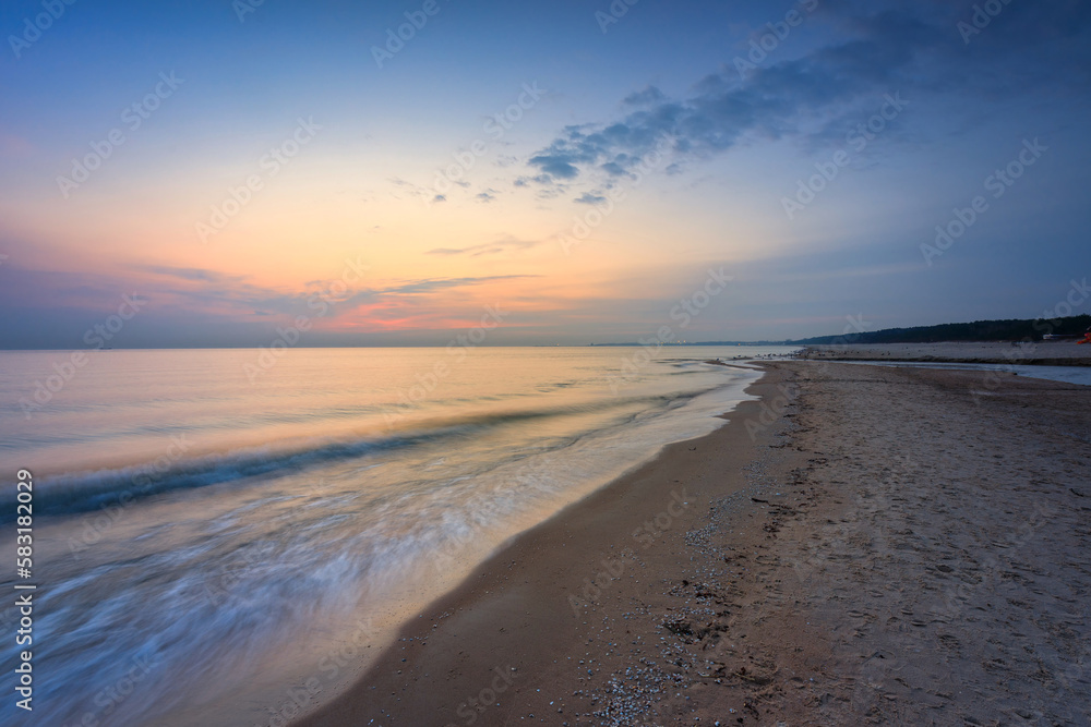 Beach of the Baltic Sea in Gdansk at sunrise. Poland Beach of the Baltic Sea in Gdansk at sunrise. Poland