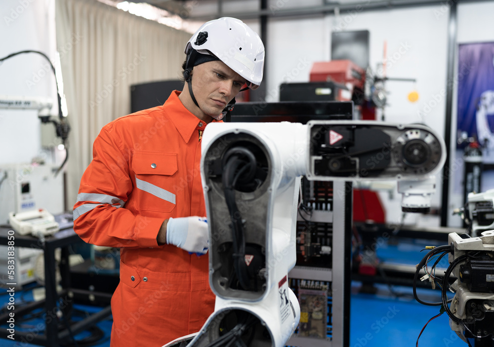 Caucasian technician engineer man with checking machine arm robot at factory Caucasian technician engineer man with checking machine arm robot at factory