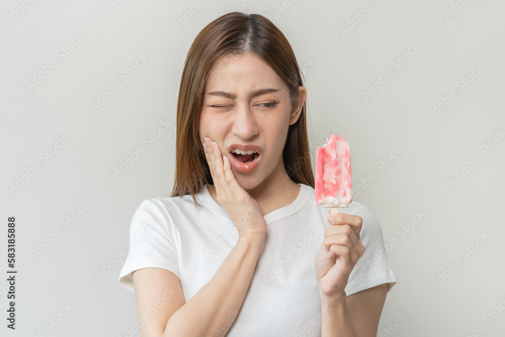 Face expression suffering from sensitive teeth and cold, asian young
