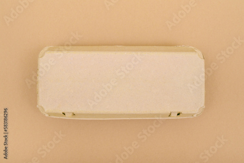 Closed egg box with ten eggs. Close carton pack or egg container top view with copy space. Egg box with chicken eggs, carton pack or egg container.