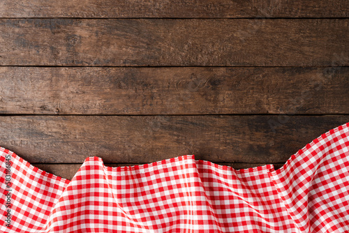 Checkered tablecloth on wooden background with copyspace