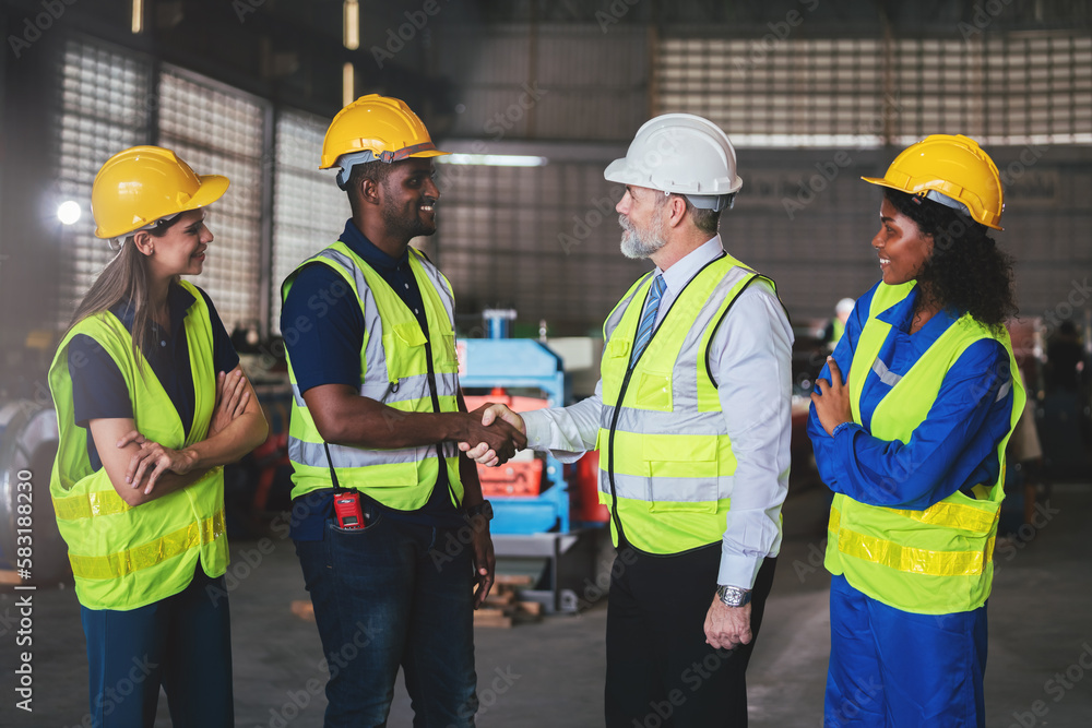 Diverse people working together with colleague in factory, Cooperation in factory with engineers and technician hand shaking to work together on big industrial project. Diverse people working together with colleague in factory, Cooperation in factory with engineers and technician hand shaking to work together on big industrial project.