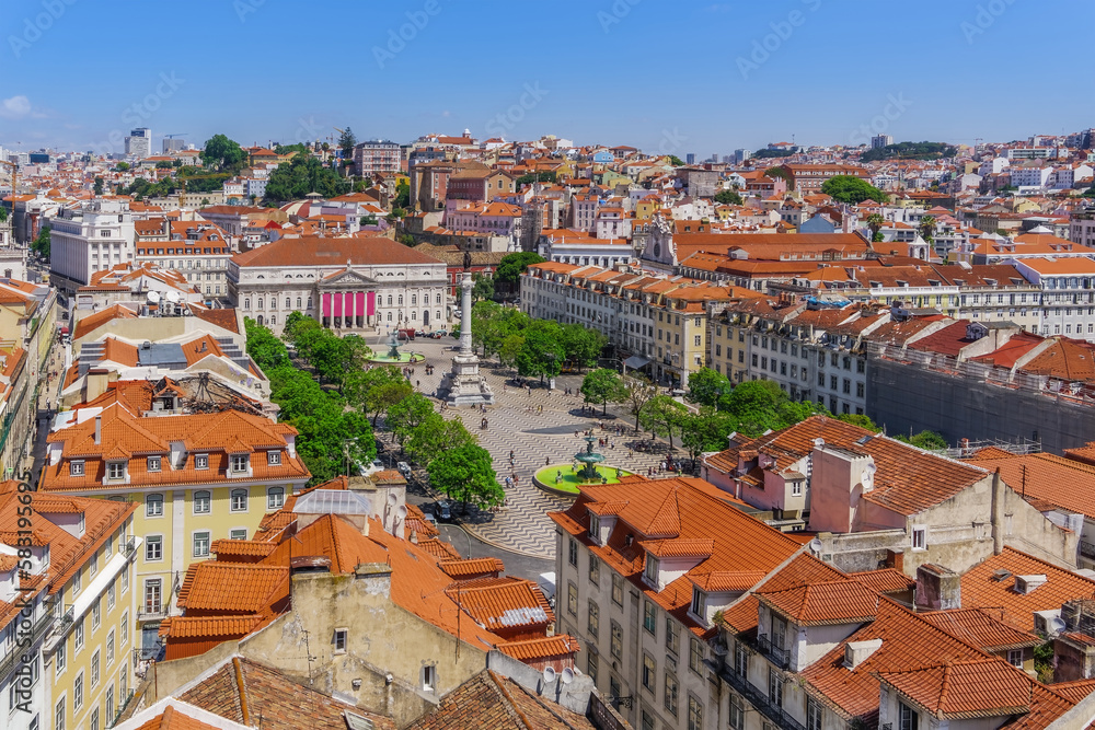 Lisbon, Portugal panoramic landscape of Dom Pedro IV square, Praca Dom Pedro IV, with column surrounded by traditional low-rise red tile rooftop buildings and Teatro Nacional D. Maria II.