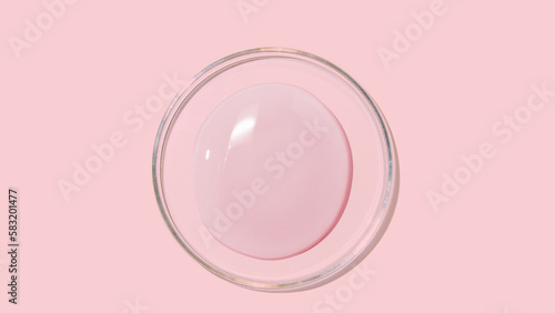 large drops of cosmetic serum, liquid, water, gel on a pink background