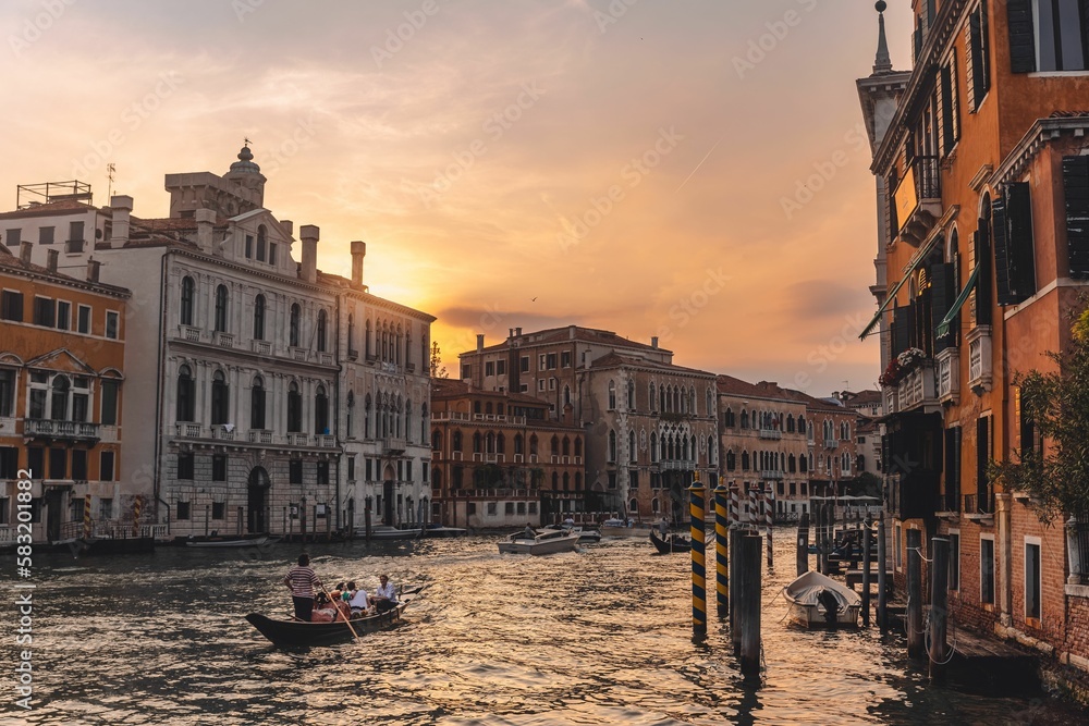 Beautiful shot of historic buildings on the shore of the canal with a gondola in Venice, Italy