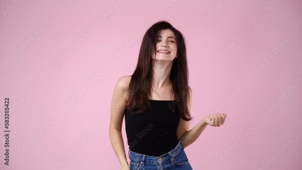4k video of one girl is so excited about something over pink background. 4k video of one girl is so excited about something over pink background.