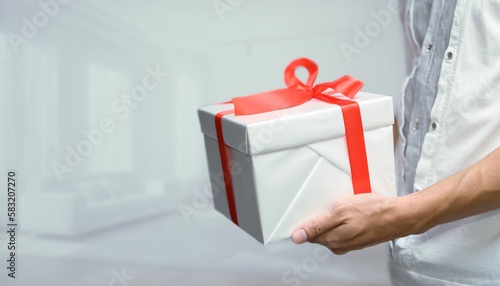 A man holding a present with a bow, the concept of giving gifts for  birthdays, and other occasions