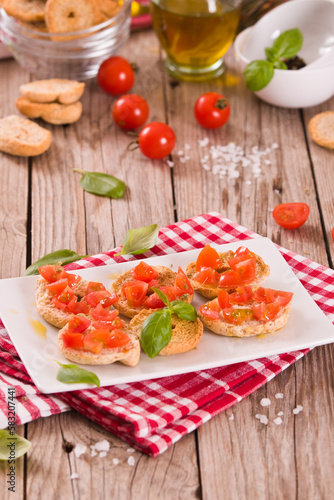 Friselle with cherry tomatoes and basil.