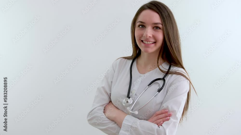 Beautiful young African American nurse or doctor with stethoscope stands, looking to the right side wearing blue scrubs and long curly hair Beautiful young African American nurse or doctor with stethoscope stands, looking to the right side wearing blue scrubs and long curly hair