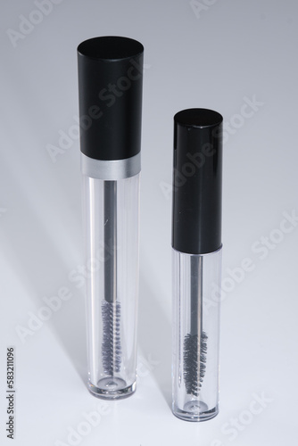 Unbranded eyeliner containers. Empty mascara bottles and applicator brushes.
