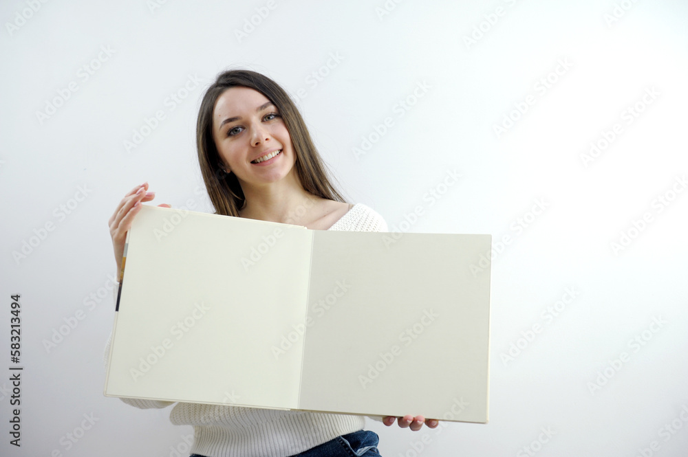 Beautiful cute girl holding a white card isolated over white. High quality photo Beautiful cute girl holding a white card isolated over white. High quality photo