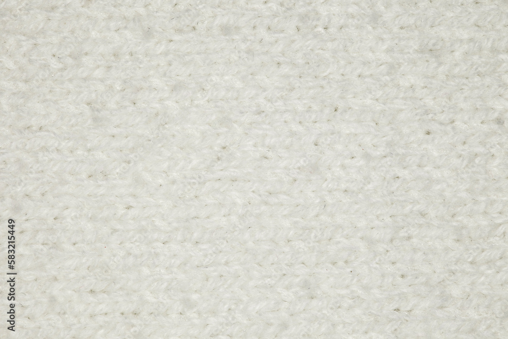 Fabric knitted with threads of white sheep wool yarn close-up, background wallpaper, uniform texture pattern Fabric knitted with threads of white sheep wool yarn close-up, background wallpaper, uniform texture pattern