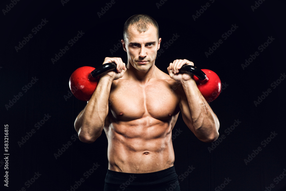 Muscular man with the kettlebells