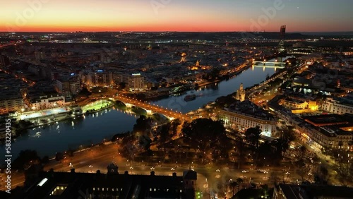 Aerial drone footage of the Seville city the Guadalquivir canal with the cathedral, the Torre del Oro, the tower of gold, Andalusia, Spaine
