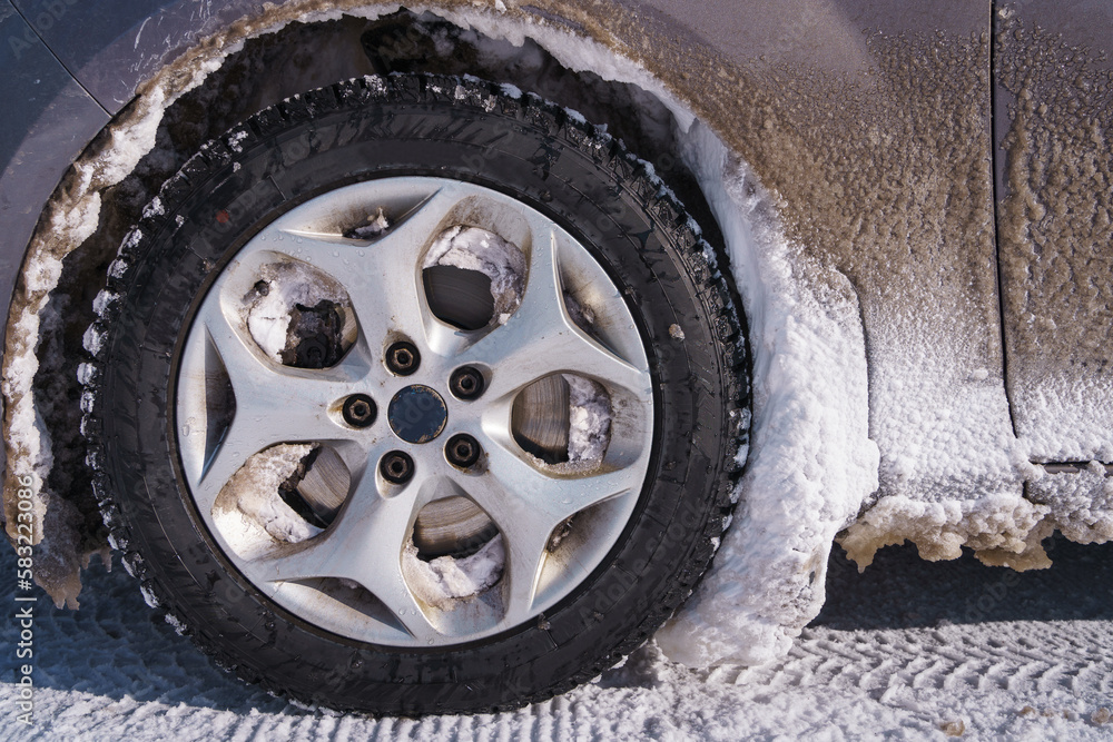 Wheel arch of a car full of snow Wheel arch of a car full of snow
