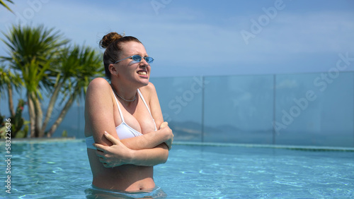 Fotografija young woman in cold pool, wrinkled from the cold water at the summer in a hotel
