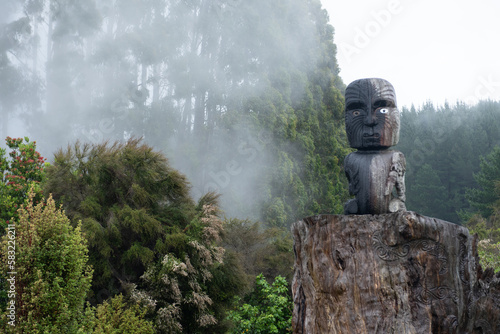 Maori tiki statue surrounded by mist in Waikato Aotearoa New Zealand in nature