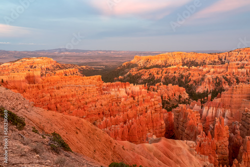 Aerial sunset view of massive hoodoo sandstone rock formation boat mesa in Bryce Canyon National Park  Utah  USA. Last sun rays touching on natural unique amphitheatre sculpted from red rock. Twilight