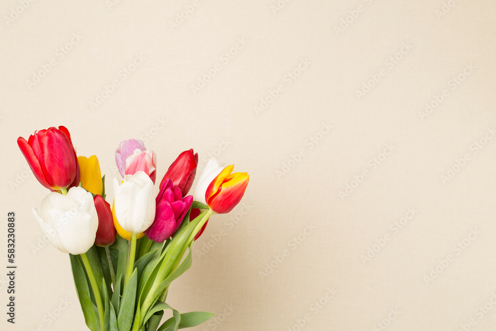 Tulip flowers in vase on wooden table, closeup view