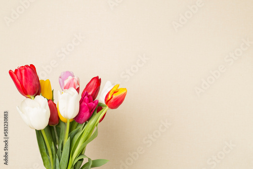 Tulip flowers in vase on wooden table  closeup view