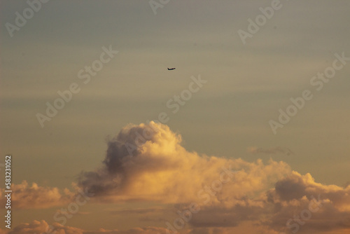 Plane in the sky at sunset © Hector