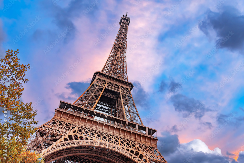 The Eiffel Tower in Paris against the backdrop of a beautiful evening sky.