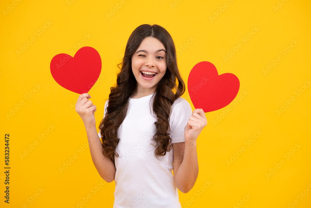 Young teenager child girl with heart shape. Happy Valentines Day. Love and pleasant feelings concept. Happy teenager, positive and smiling emotions of teen girl. Young teenager child girl with heart shape. Happy Valentines Day. Love and pleasant feelings concept. Happy teenager, positive and smiling emotions of teen girl.