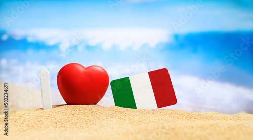 I love Italy and Sardinia. Flag of Italy on the beach with a red heart. vacation and travel concept.