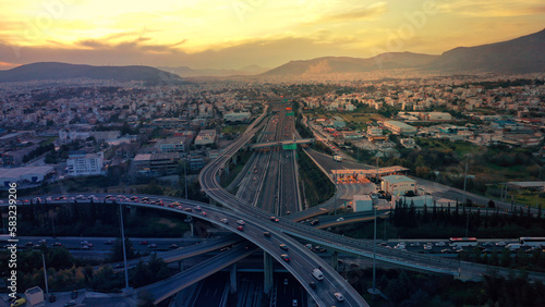 Aerial drone photo of modern Attiki Odos toll multilevel interchange highway with National road in Attica area at sunset, Athens, Greece