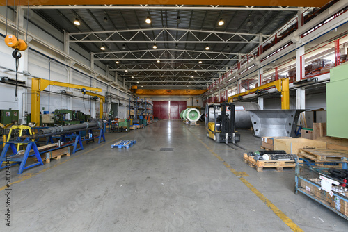 A large industrial warehouse with newly manufactured heavy equipment